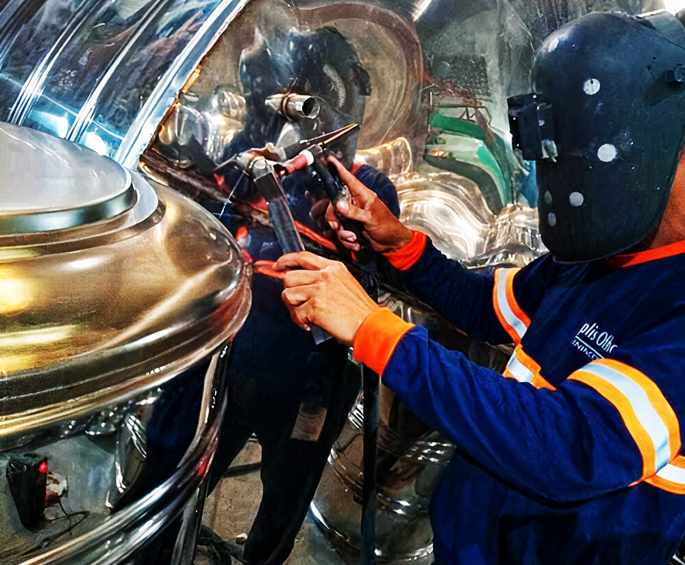 A general contractor from TOTC Inc disassembling metallic cylinder while wearing safety gears