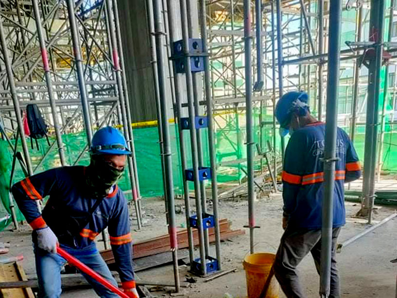 Construction worker using protective helmet and gloves